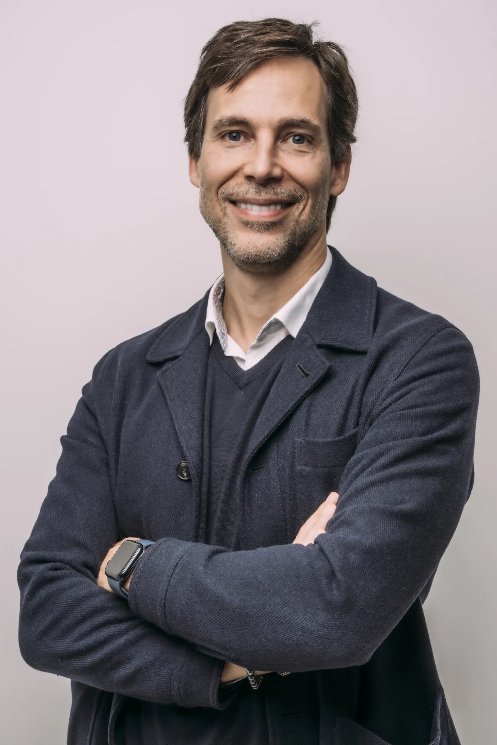 Dr Pedro Gutierres in a grey blazer, arms crossed
